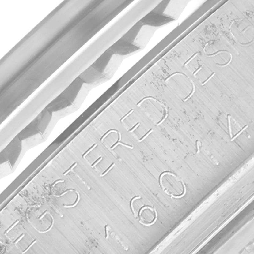 The image shows a close-up of the engraved side of the Rolex Datejust 16014 Men
s Stainless Steel Silver Dial 16014 Men
s Stainless Steel Silver Dial watch, highlighting the bezel and part of the case.