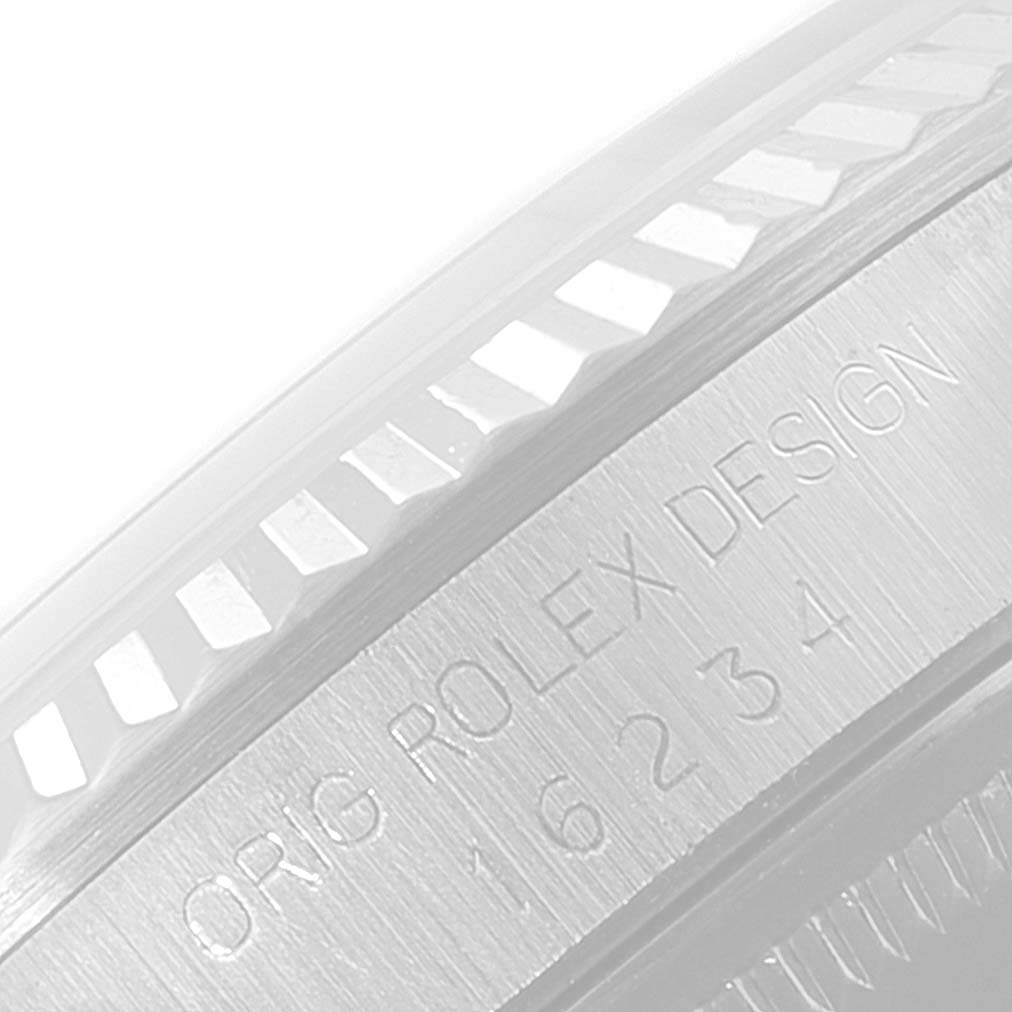 The image shows an angled close-up of the engraved bezel and serial number area of the Rolex Datejust 16234 Men's Stainless Steel Silver Dial 16234 Men's Stainless Steel Silver Dial watch.