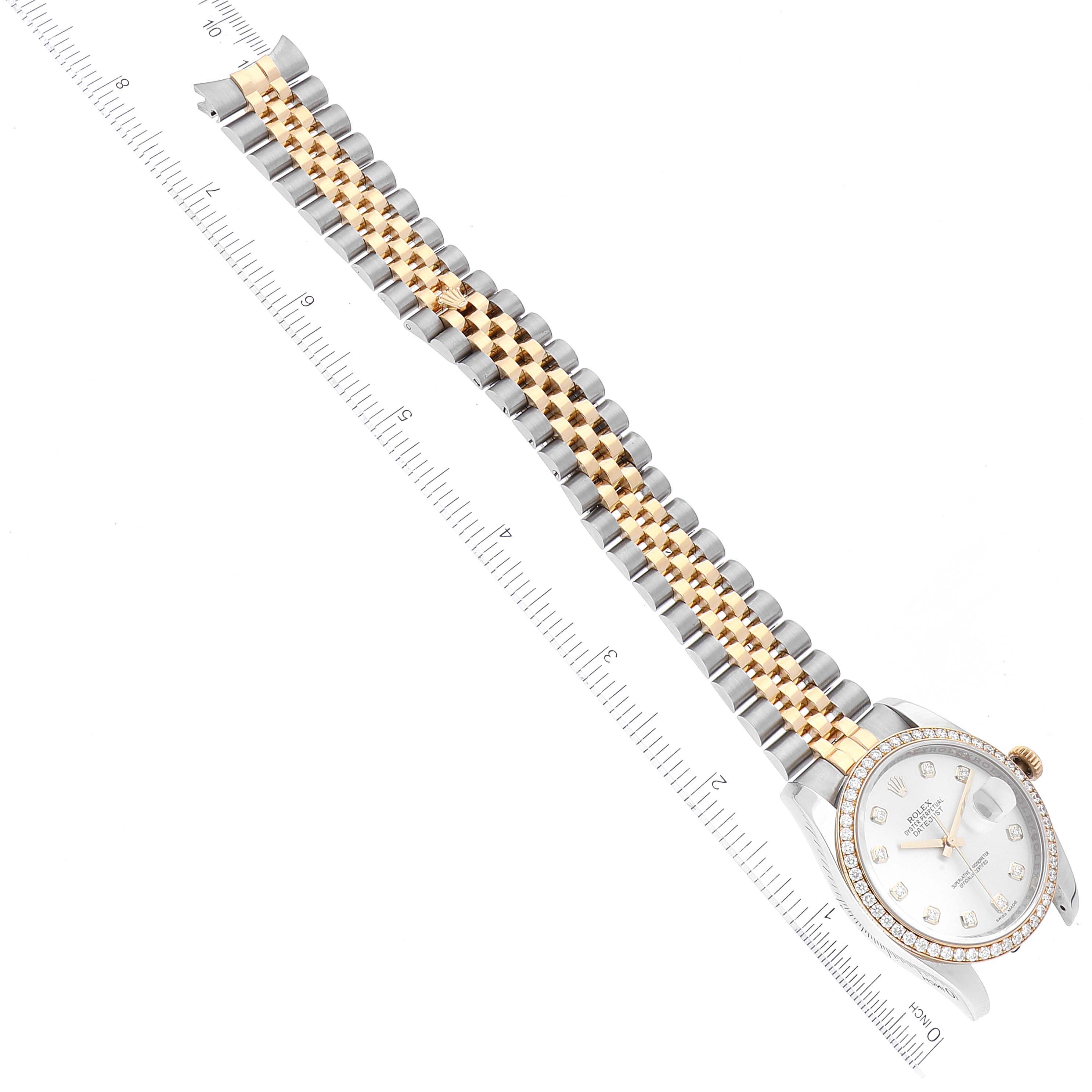 The image shows a Rolex Datejust 116243 Men's Steel and Gold (two tone) Silver Dial 116243 Men's Steel and Gold (two tone) Silver Dial watch from an angled top-down perspective, highlighting its bracelet and face against a ruler for scale.