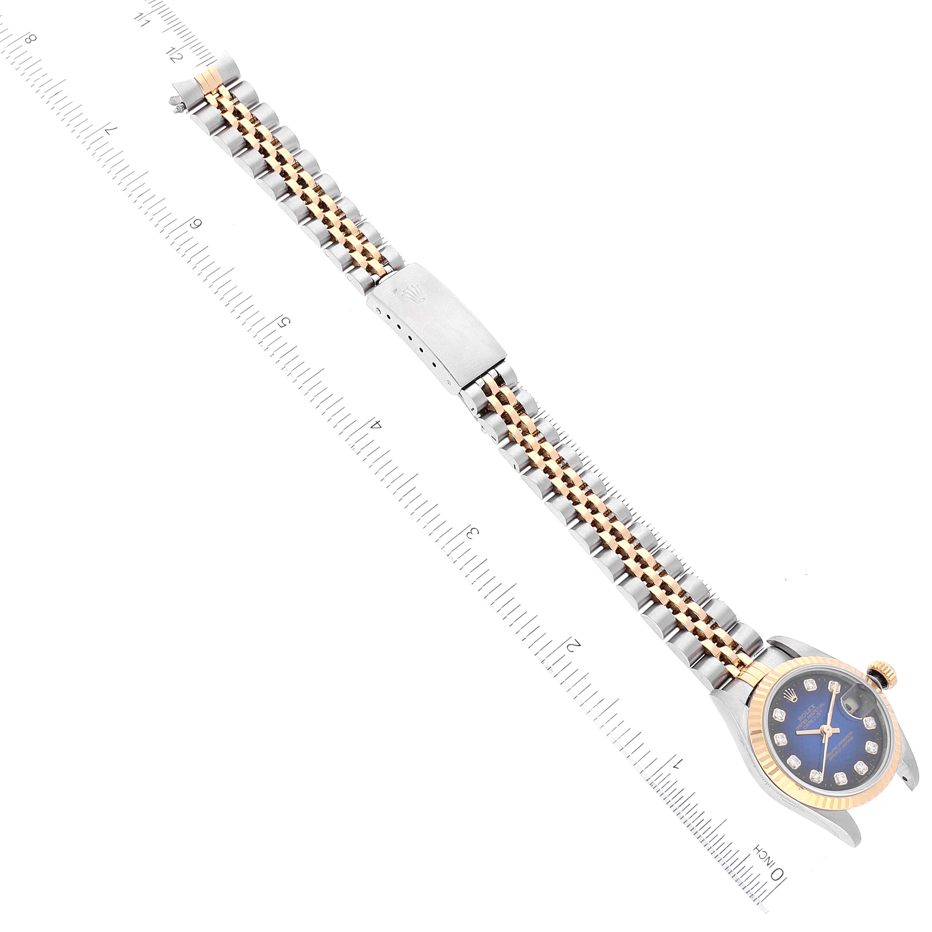 The image shows the side and top view of a Rolex Datejust 69173 Women's Steel and Gold (two tone) Blue Dial 69173 Women's Steel and Gold (two tone) Blue Dial watch with a two-tone metal bracelet, alongside a ruler for scale.