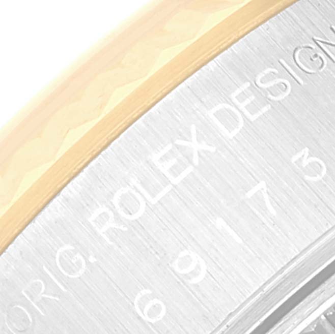 This close-up image of a Rolex Datejust 69173 Women's Steel and Gold (two tone) Blue Dial 69173 Women's Steel and Gold (two tone) Blue Dial watch shows part of the bezel and the engraved text on the side.