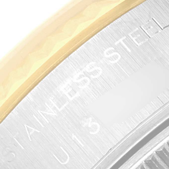 This close-up image shows the stainless steel and gold fluted bezel of a Rolex Datejust 69173 Women's Steel and Gold (two tone) Blue Dial 69173 Women's Steel and Gold (two tone) Blue Dial watch.