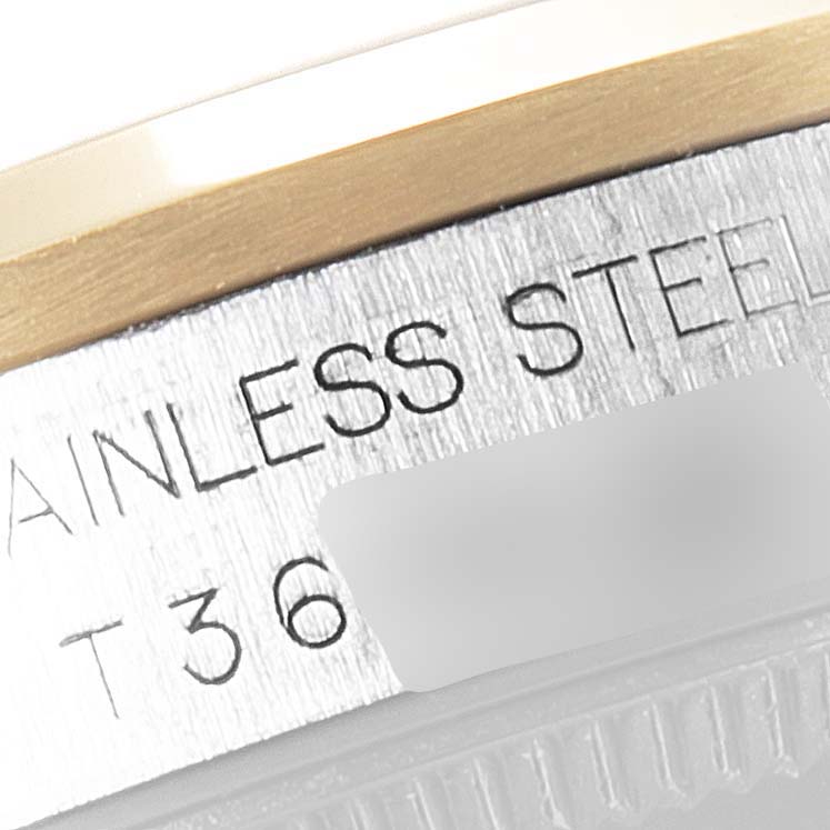 This close-up image shows the stainless steel and gold bezel of a Mid-Size Rolex watch.