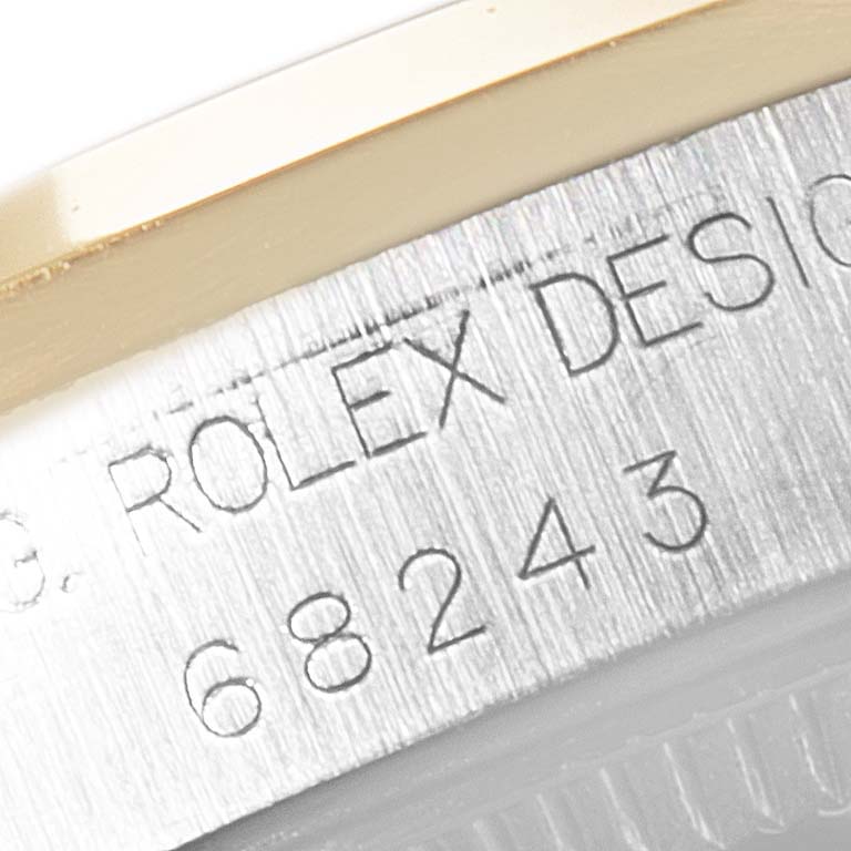 This close-up shows the model number and "Rolex Design" engraving on the side of the Mid-Size Rolex watch case.