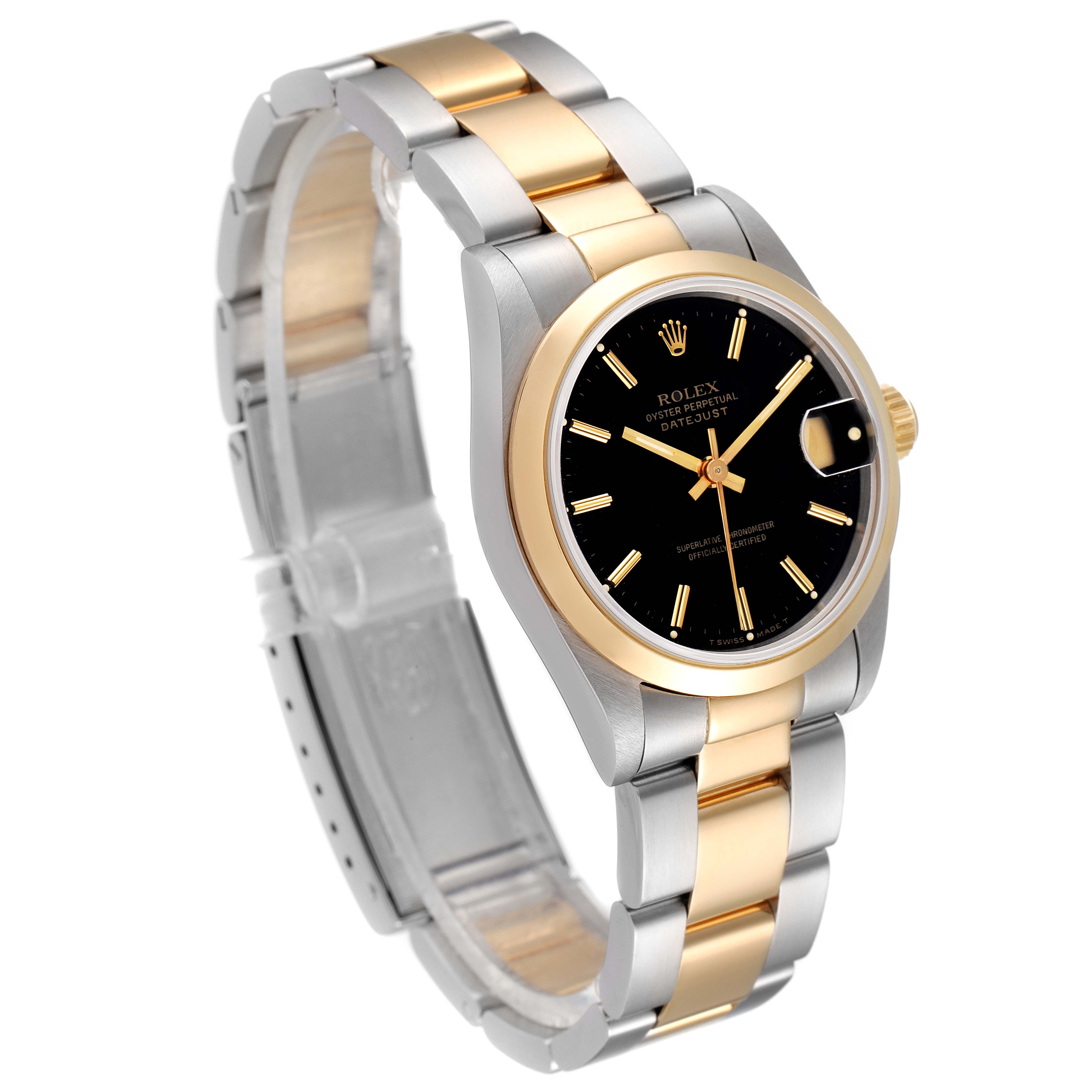 The image shows a Rolex Mid-Size 68243 Women
s Steel and Gold (two tone) Black Dial 68243 Women
s Steel and Gold (two tone) Black Dial Datejust watch slightly tilted left, emphasizing its two-tone bracelet, black dial, and gold bezel.