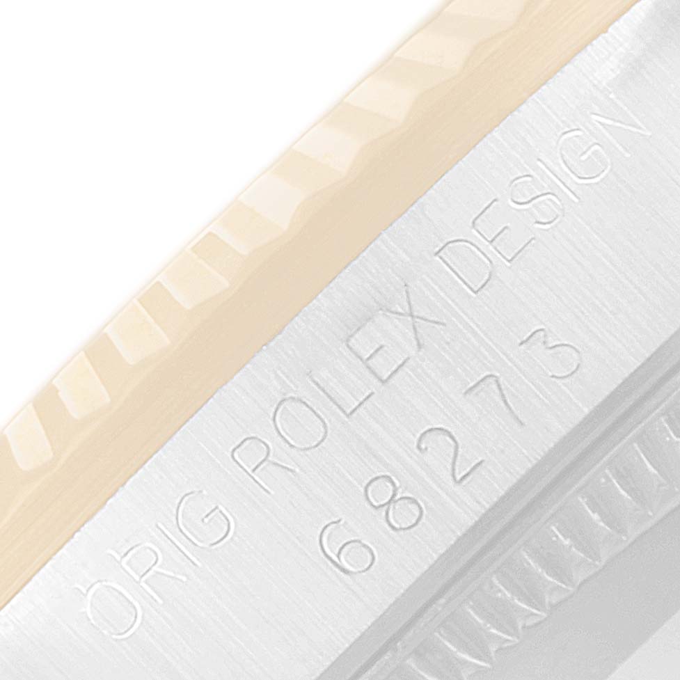 The image shows a close-up of the case side of the Rolex Mid-Size 68273 Women
s Steel and Gold (two tone) Champagne Dial 68273 Women
s Steel and Gold (two tone) Champagne Dial model, featuring the engraved "Orig Rolex Design" and model number.