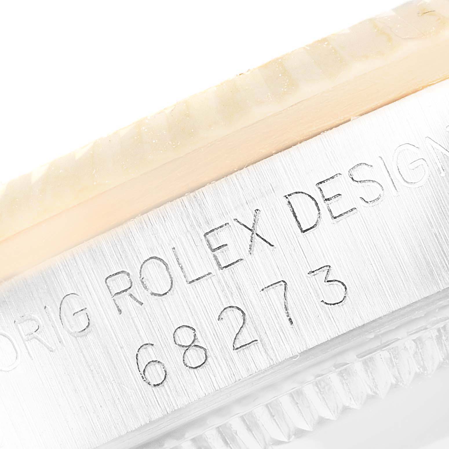 This close-up shows the side of the case of a Mid-Size Rolex watch, highlighting the engraved model number 68273.