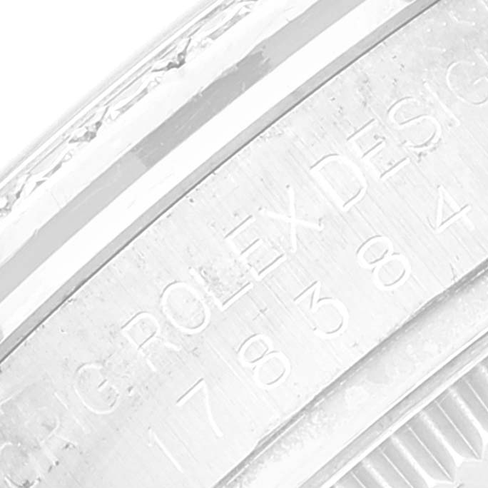 The image shows a close-up of the case side of a mid-size Rolex watch, highlighting the engraved serial number.