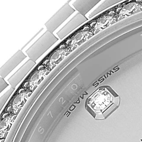This close-up of a Rolex Mid-Size 178384 Women
s Stainless Steel Silver Dial 178384 Women
s Stainless Steel Silver Dial model watch shows part of the bezel, dial, and a portion of the bracelet.