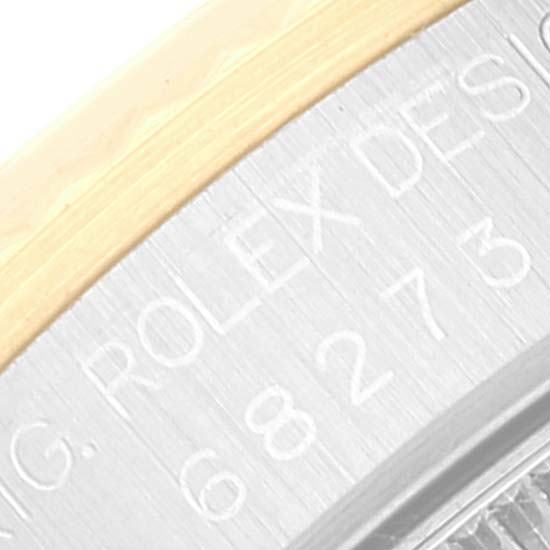 The image shows a close-up of the side edge and engravings on the casing of a mid-size Rolex watch.