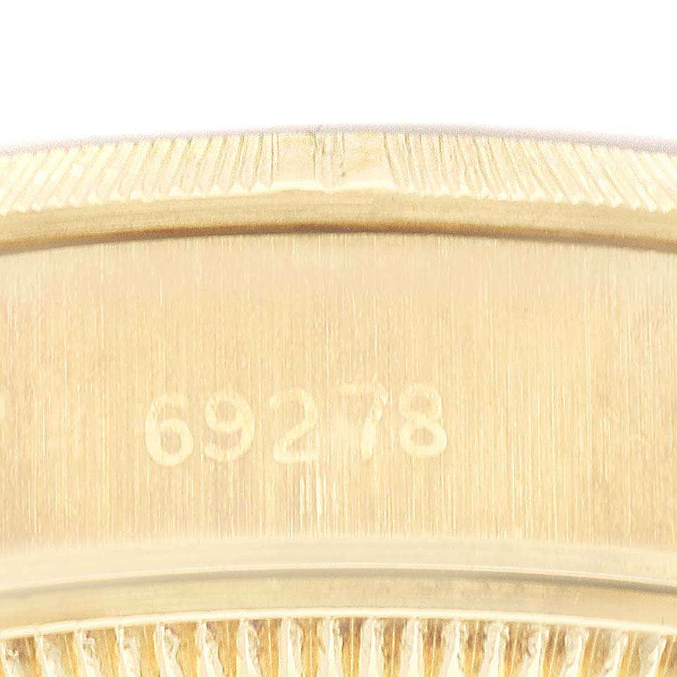 This image shows a close-up of the serial number engraved on the bezel of a Rolex President 69278G Women
s Yellow Gold Champagne Dial 69278G Women
s Yellow Gold Champagne Dial model watch.