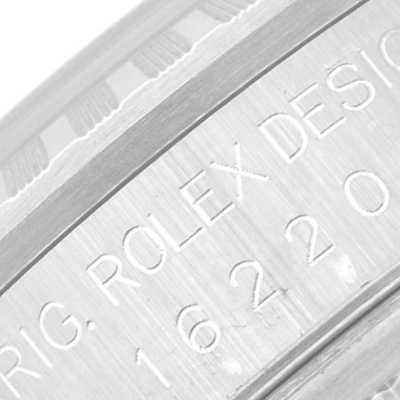This image shows the engraved serial numbers on the side of the case of a Rolex Datejust 16220 Men's Stainless Steel Silver Dial 16220 Men's Stainless Steel Silver Dial watch.