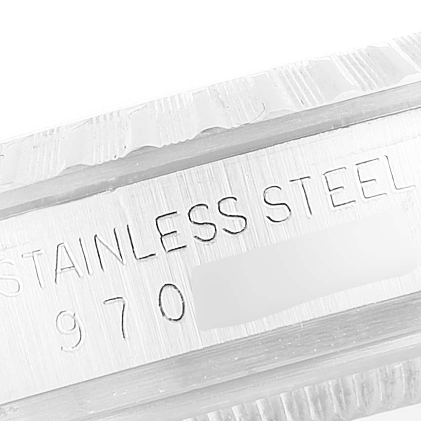 The image shows a close-up of the engraved stainless steel case of a Vintage Collection model by Rolex.