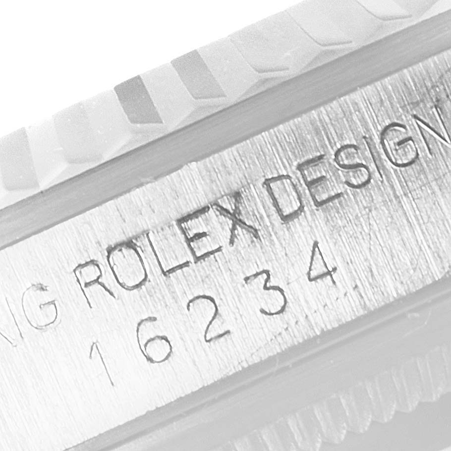 The image shows a close-up of the engraved model and serial number on the side of a Rolex Datejust 16234 Men's Stainless Steel Silver Dial 16234 Men's Stainless Steel Silver Dial watch case.