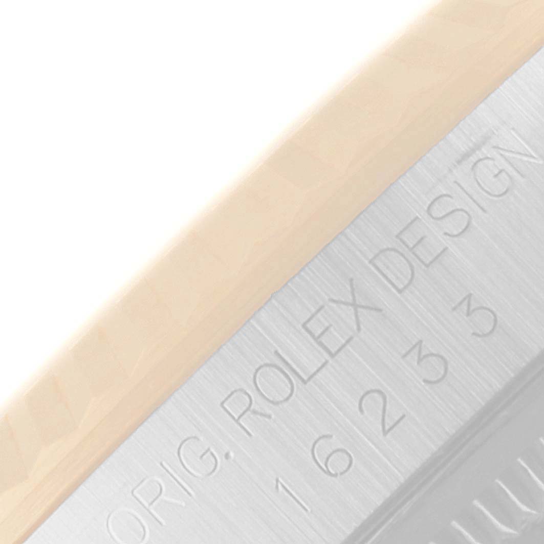 The image shows a close-up of the side of a Rolex Datejust 16233 Men's Steel and Gold (two tone) Black Dial 16233 Men's Steel and Gold (two tone) Black Dial watch, focusing on the engraved model numbers.