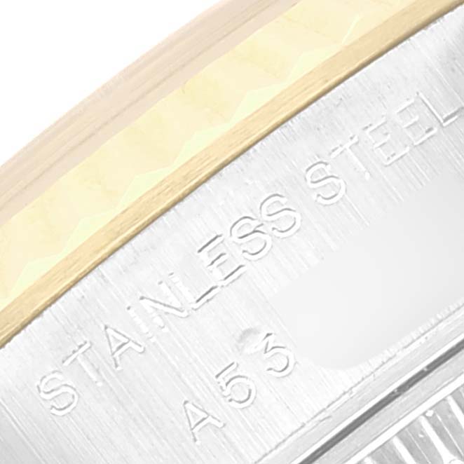 This close-up image showcases a portion of the bezel and case back inscription of a Rolex Datejust 79173 Women's Steel and Gold (two tone) Champagne Dial 79173 Women's Steel and Gold (two tone) Champagne Dial watch.