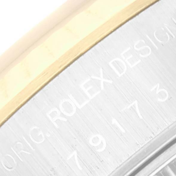 This close-up image shows part of the case side, with the engravings visible, of a Rolex Datejust 79173 Women's Steel and Gold (two tone) Champagne Dial 79173 Women's Steel and Gold (two tone) Champagne Dial watch.