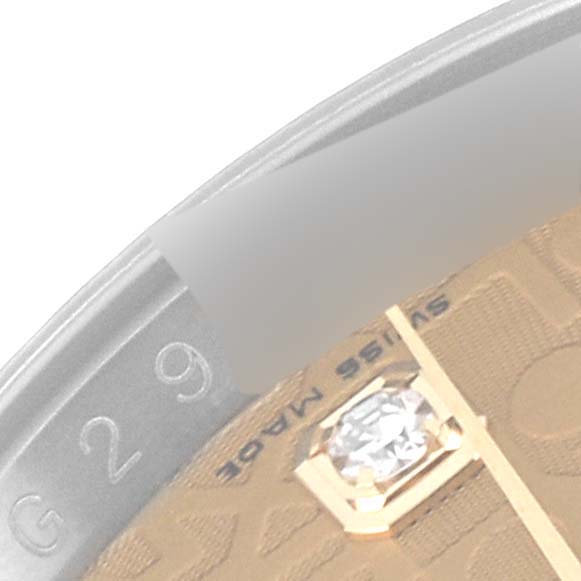 The image shows a close-up of the dial and bezel of a Rolex Datejust 116233 Men's Steel and Gold (two tone) Champagne Dial 116233 Men's Steel and Gold (two tone) Champagne Dial watch, highlighting the diamond marker and part of the inscription.