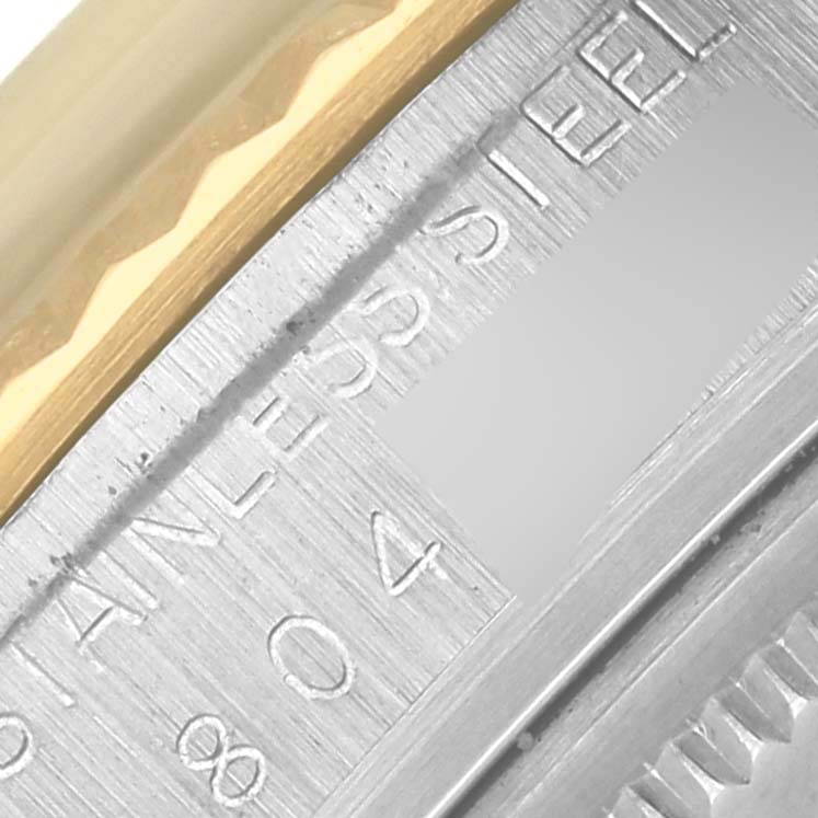 The image shows a close-up of the side of a Rolex Datejust 16013 Men's Steel and Gold (two tone) Champagne Dial 16013 Men's Steel and Gold (two tone) Champagne Dial, highlighting its stainless steel and gold case.