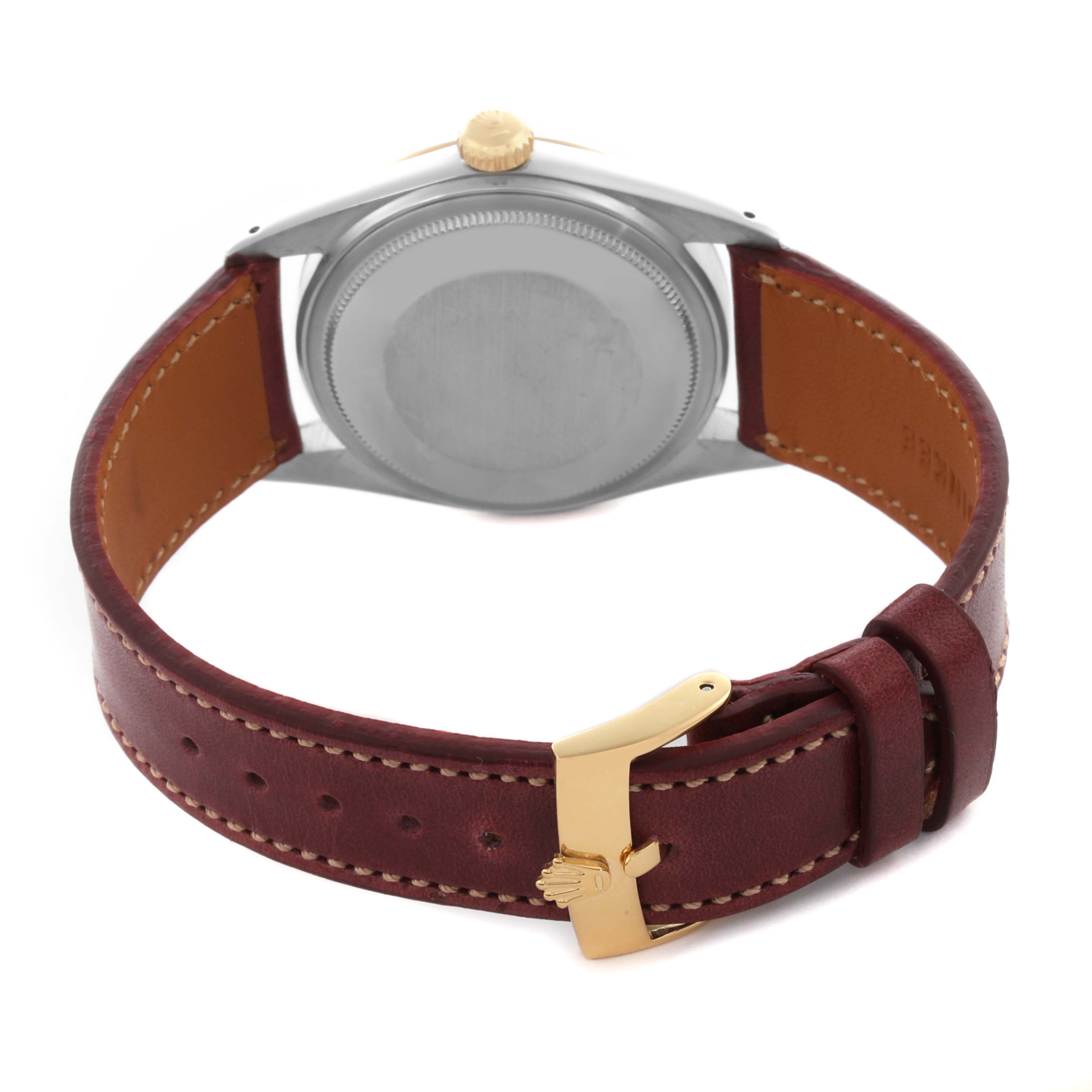 The Rolex Datejust 16013 Men's Steel and Gold (two tone) Champagne Dial 16013 Men's Steel and Gold (two tone) Champagne Dial watch is shown from the back, highlighting its case, crown, and brown leather strap with a gold clasp.