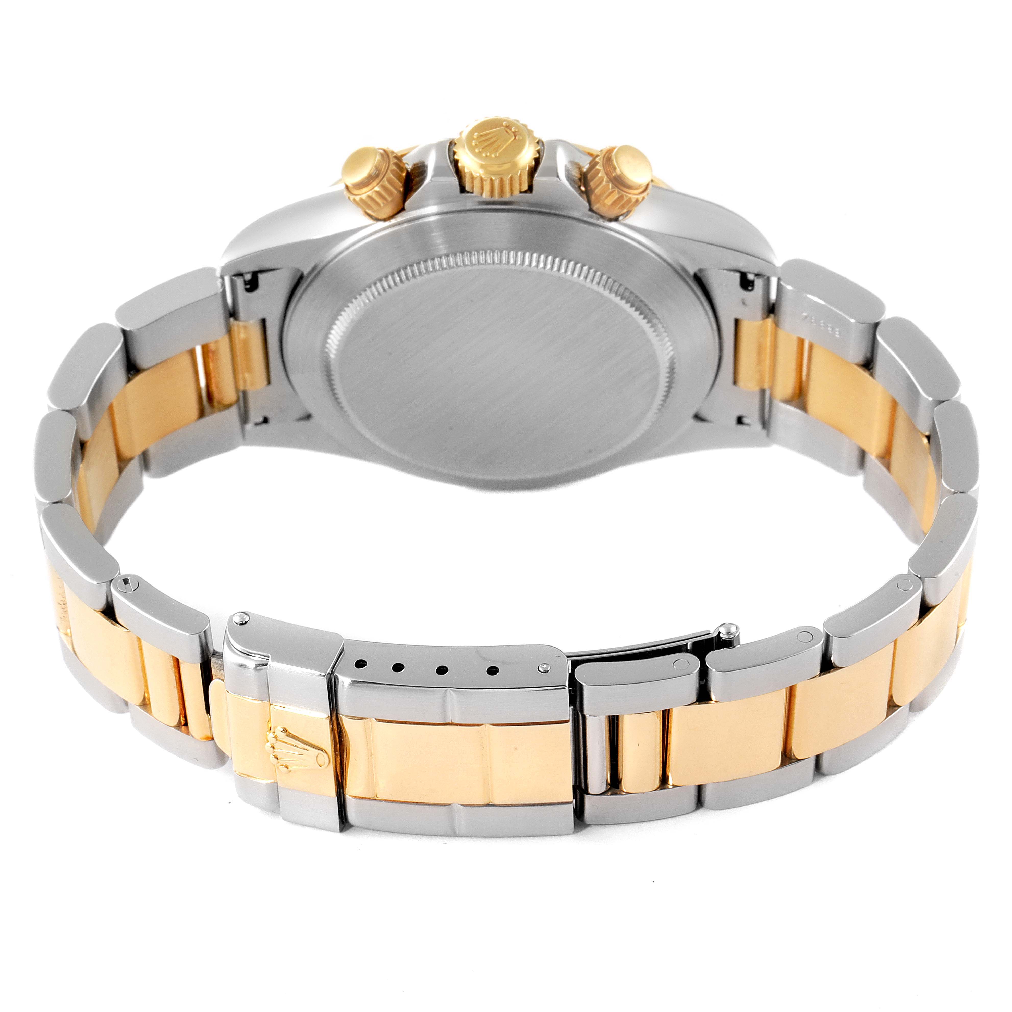 The image shows the back and bracelet of a two-tone Rolex Daytona 16523 Men
s Steel and Gold (two tone) Black Dial 16523 Men
s Steel and Gold (two tone) Black Dial watch, highlighting the clasp and crown.