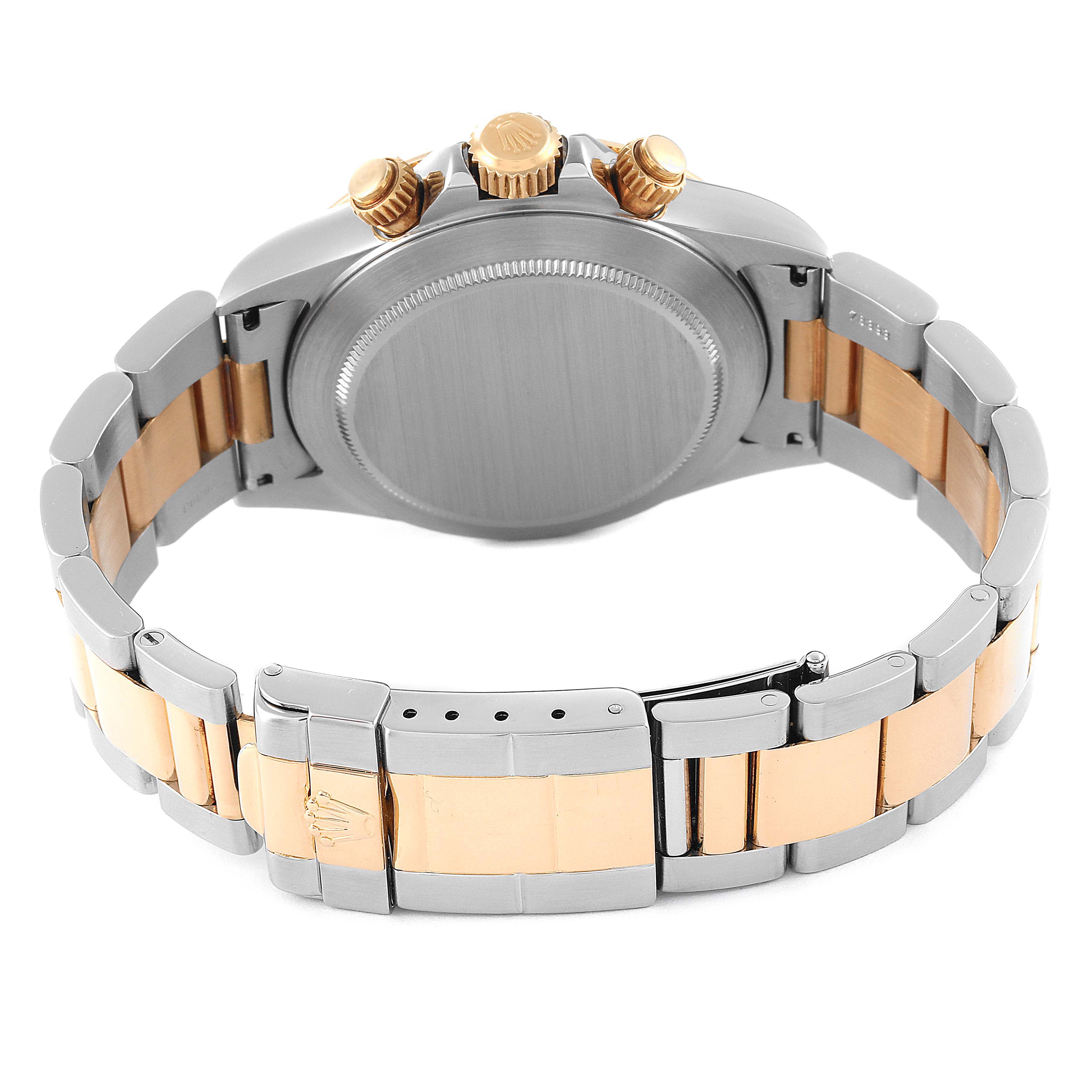 The image shows the back view and bracelet of the Rolex Daytona 16523 Men's Steel and Gold (two tone) White Dial 16523 Men's Steel and Gold (two tone) White Dial watch, revealing its clasp and crown.