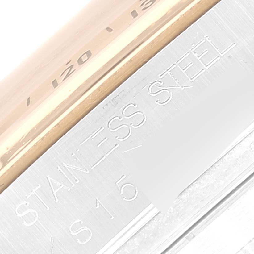 The image shows a close-up of the engravings on the stainless steel part of a Rolex Daytona 16523 Men's Steel and Gold (two tone) White Dial 16523 Men's Steel and Gold (two tone) White Dial watch.