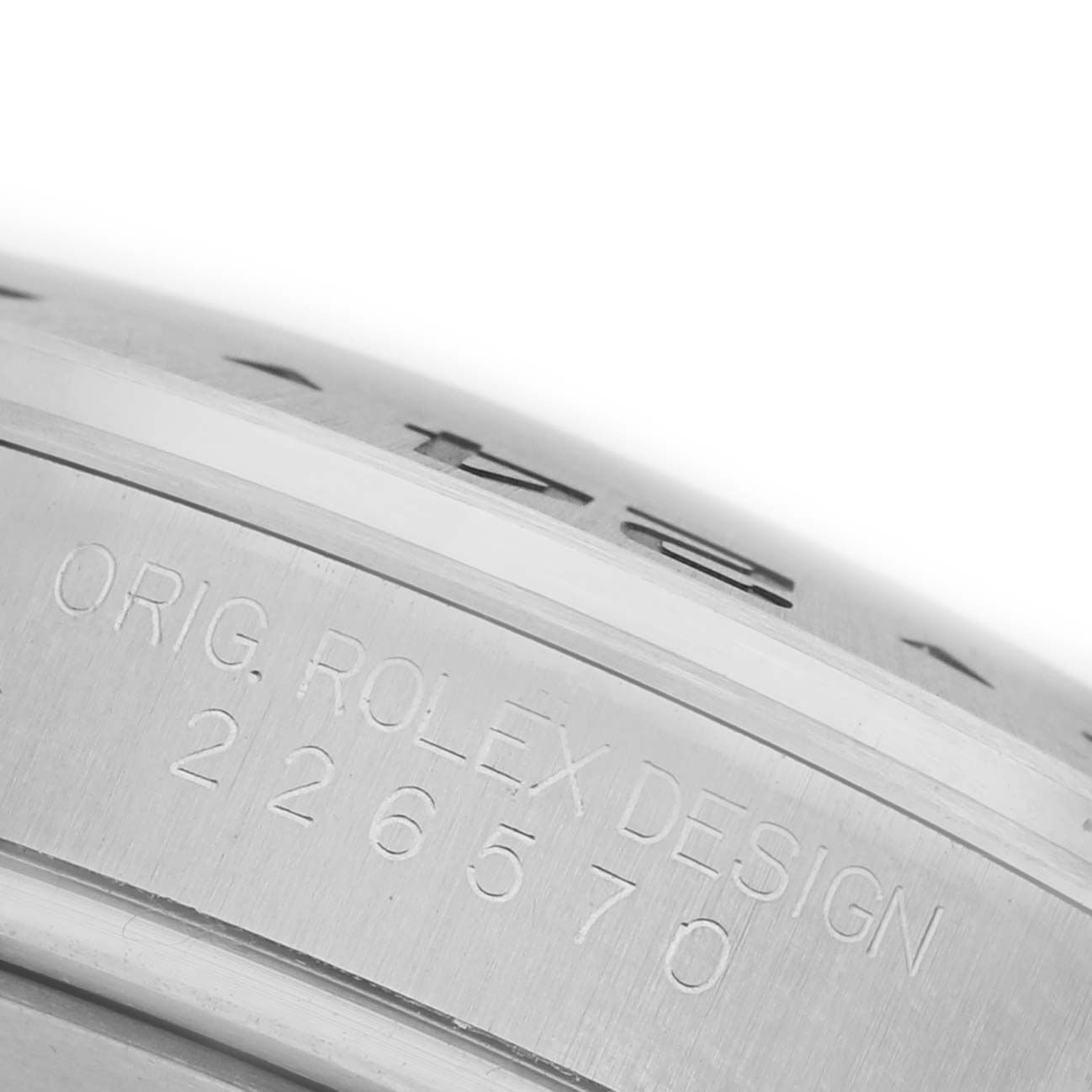 The image shows a close-up of the side of the bezel and case, featuring the serial engraving of the Rolex Explorer M226570-0002 Men's Stainless Steel Black Dial M226570-0002 Men's Stainless Steel Black Dial model.