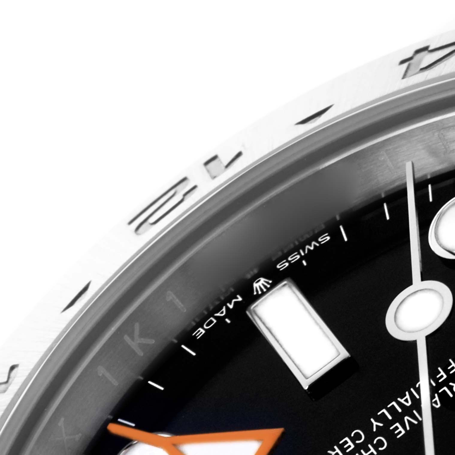 The image shows a close-up of the Rolex Explorer M226570-0002 Men's Stainless Steel Black Dial M226570-0002 Men's Stainless Steel Black Dial watch, highlighting the bezel, partial dial, and hour markers.