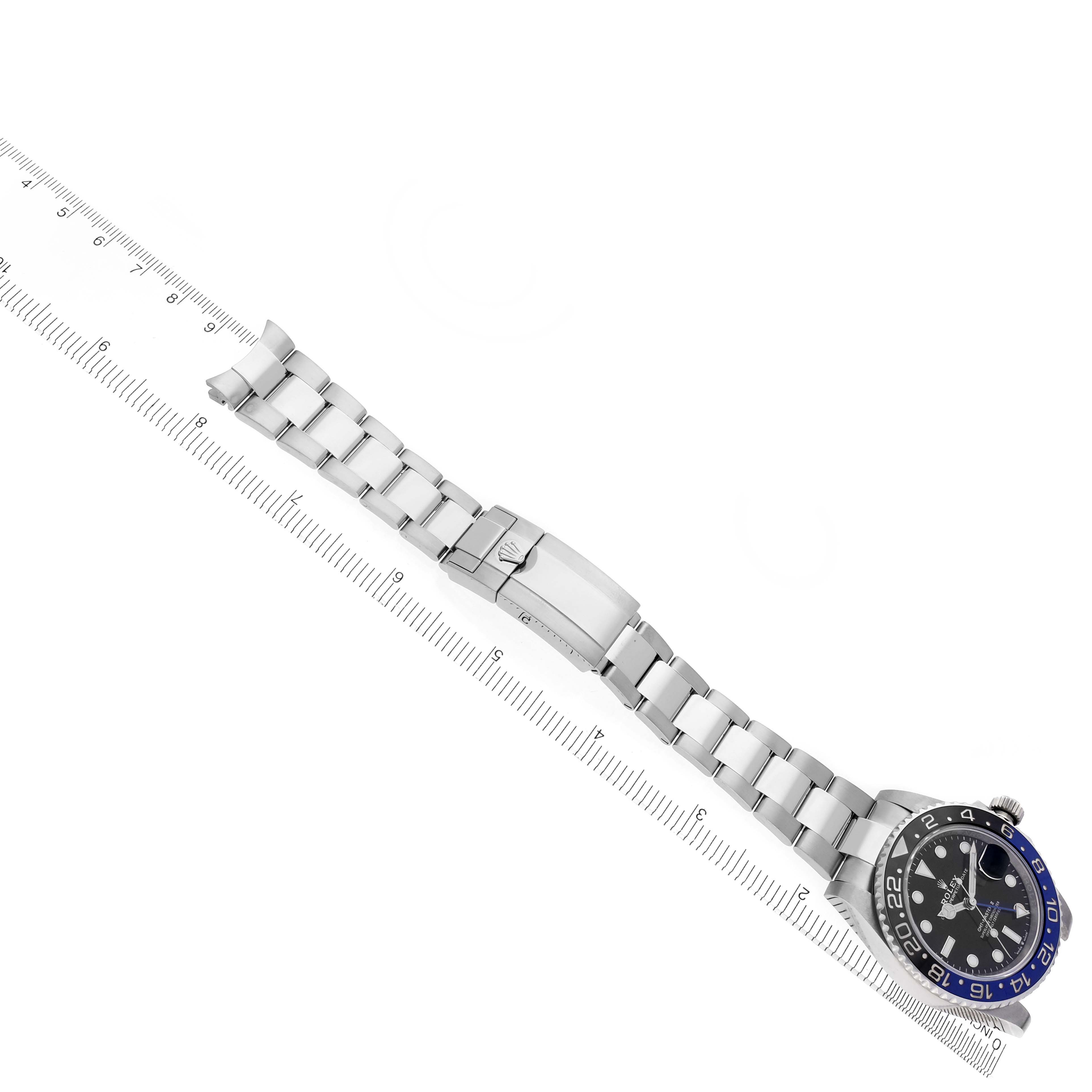 The image shows a Rolex GMT-Master 126710BLNR Men
s Stainless Steel Black Dial 126710BLNR Men
s Stainless Steel Black Dial watch flat with the bracelet fully visible, next to a ruler for scale.