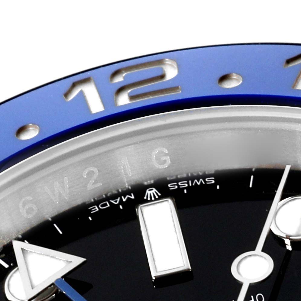 The image shows a close-up, partial view of the bezel and dial of a Rolex GMT-Master 126710BLNR Men
s Stainless Steel Black Dial 126710BLNR Men
s Stainless Steel Black Dial watch.