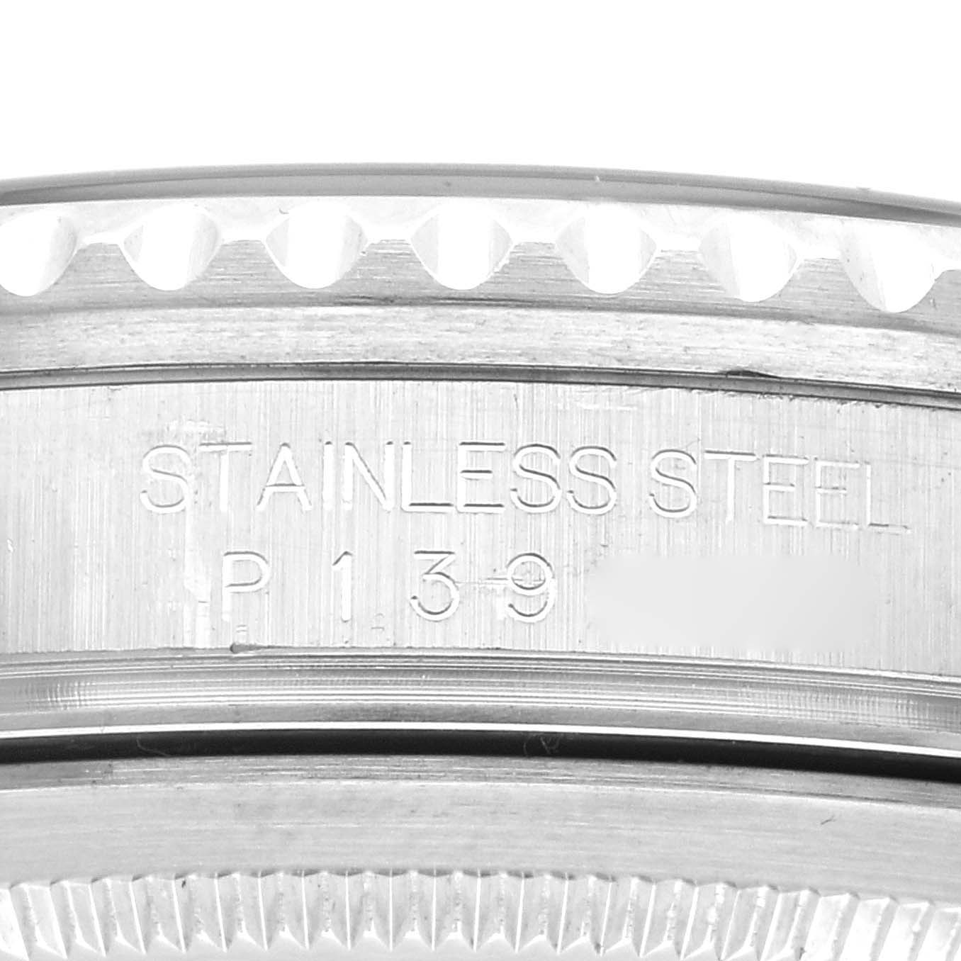 This image shows a close-up of the side of a Rolex GMT-Master 16710 Men's Stainless Steel Black Dial 16710 Men's Stainless Steel Black Dial watch, focusing on the stainless steel case with engravings.