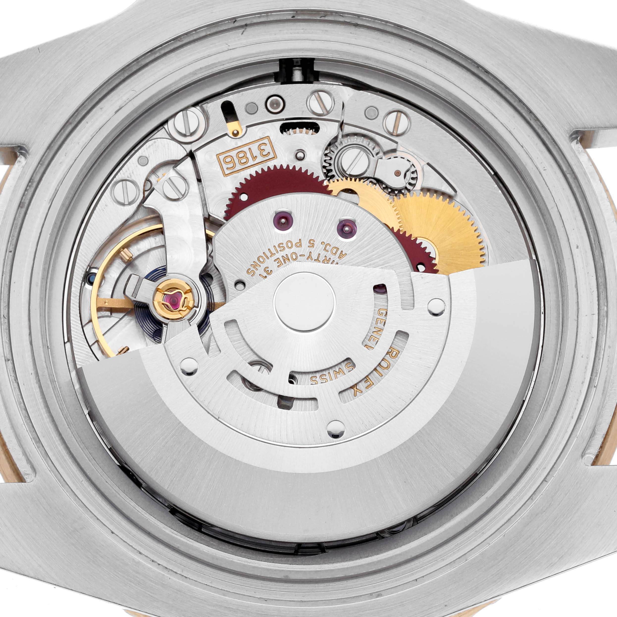 The image shows the movement of a Rolex GMT-Master 116713LN Men's Steel and Gold (two tone) Black Dial 116713LN Men's Steel and Gold (two tone) Black Dial, highlighting gears and intricate mechanical components from the back.