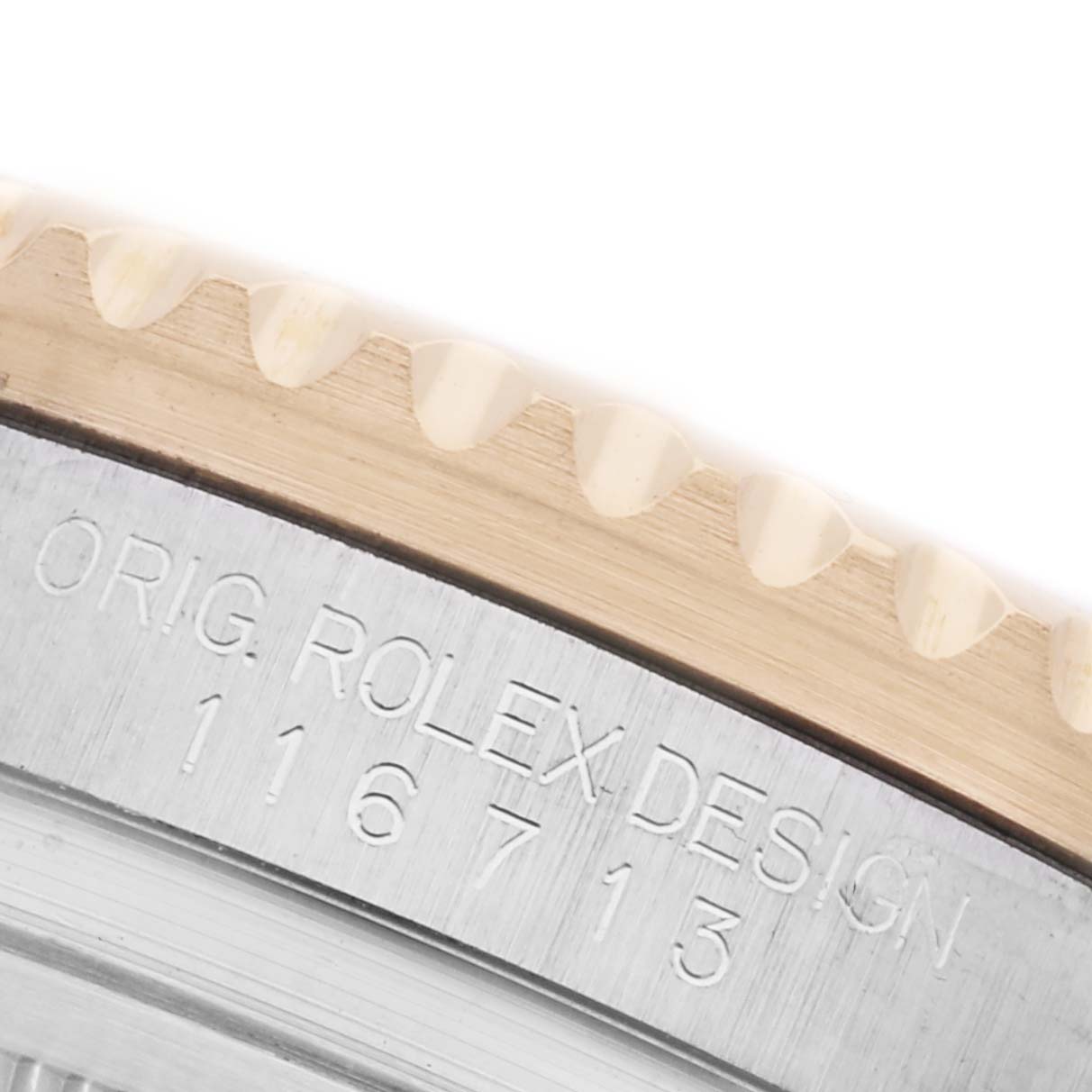 The image shows a close-up of the bezel with engraved text and teeth on the Rolex GMT-Master 116713LN Men's Steel and Gold (two tone) Black Dial 116713LN Men's Steel and Gold (two tone) Black Dial watch.