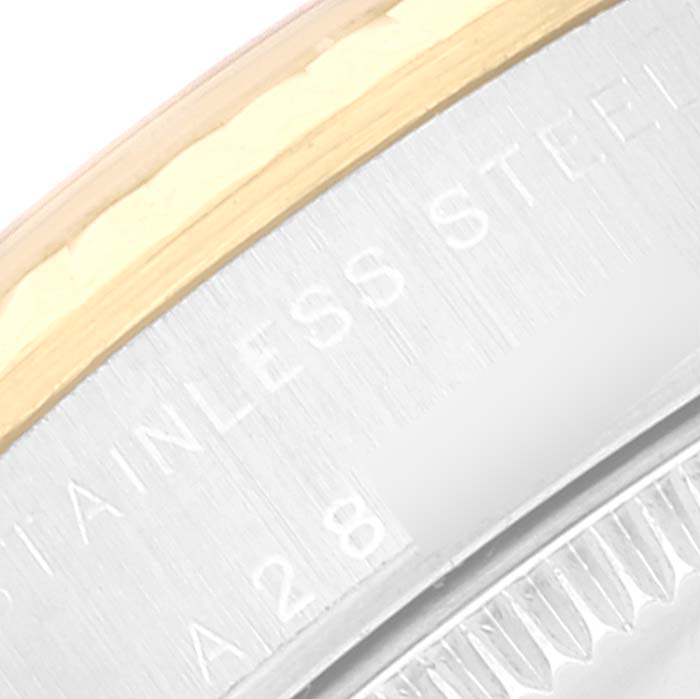 The image shows a close-up of the case back edge, emphasizing the engraving and part of the bezel of a Rolex Mid-Size 77513 Women
s Steel and Gold (two tone) White Dial 77513 Women
s Steel and Gold (two tone) White Dial model.
