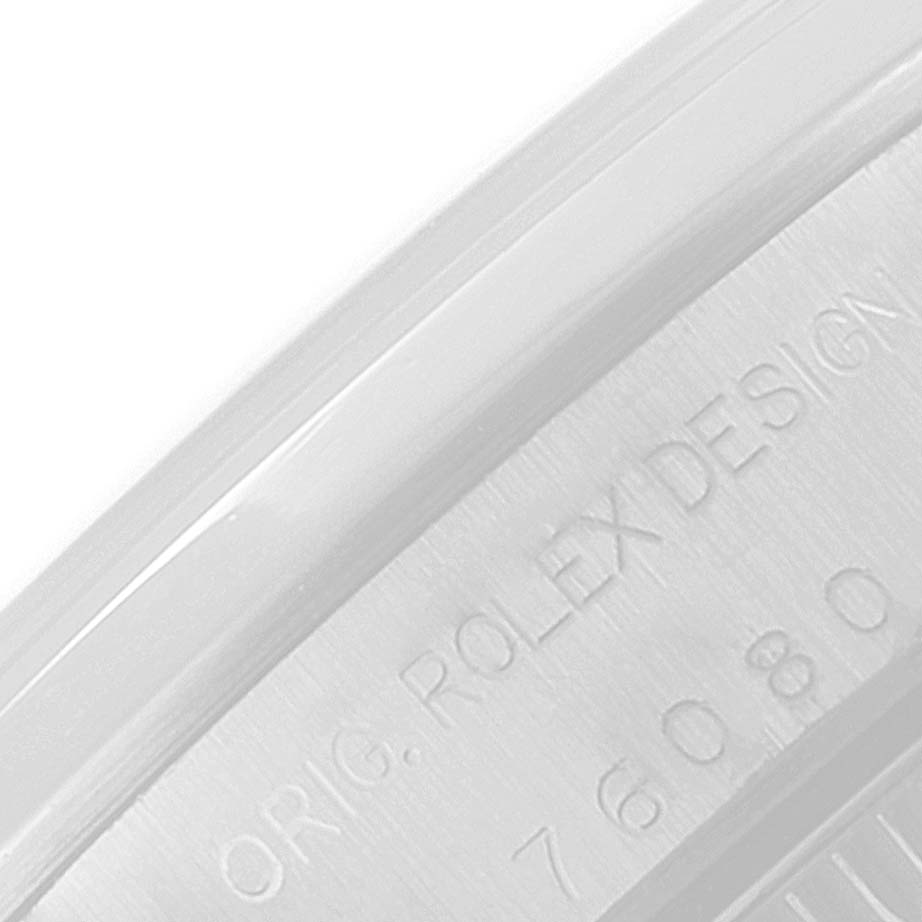 This is a close-up of the side of a Rolex Oyster Perpetual 76080 Women
s Stainless Steel Pink Dial 76080 Women
s Stainless Steel Pink Dial watch, showing part of the engraved "ORIG. ROLEX DESIGN" and model number "76080".