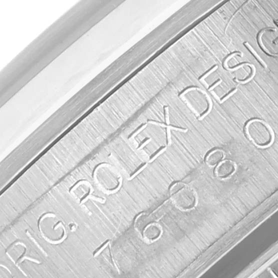 The image shows a close-up of the engraved serial number and "ROLEX DESIGN" text on the inner bezel of the Rolex Oyster Perpetual 76080 Women's Stainless Steel Pink Dial 76080 Women's Stainless Steel Pink Dial.