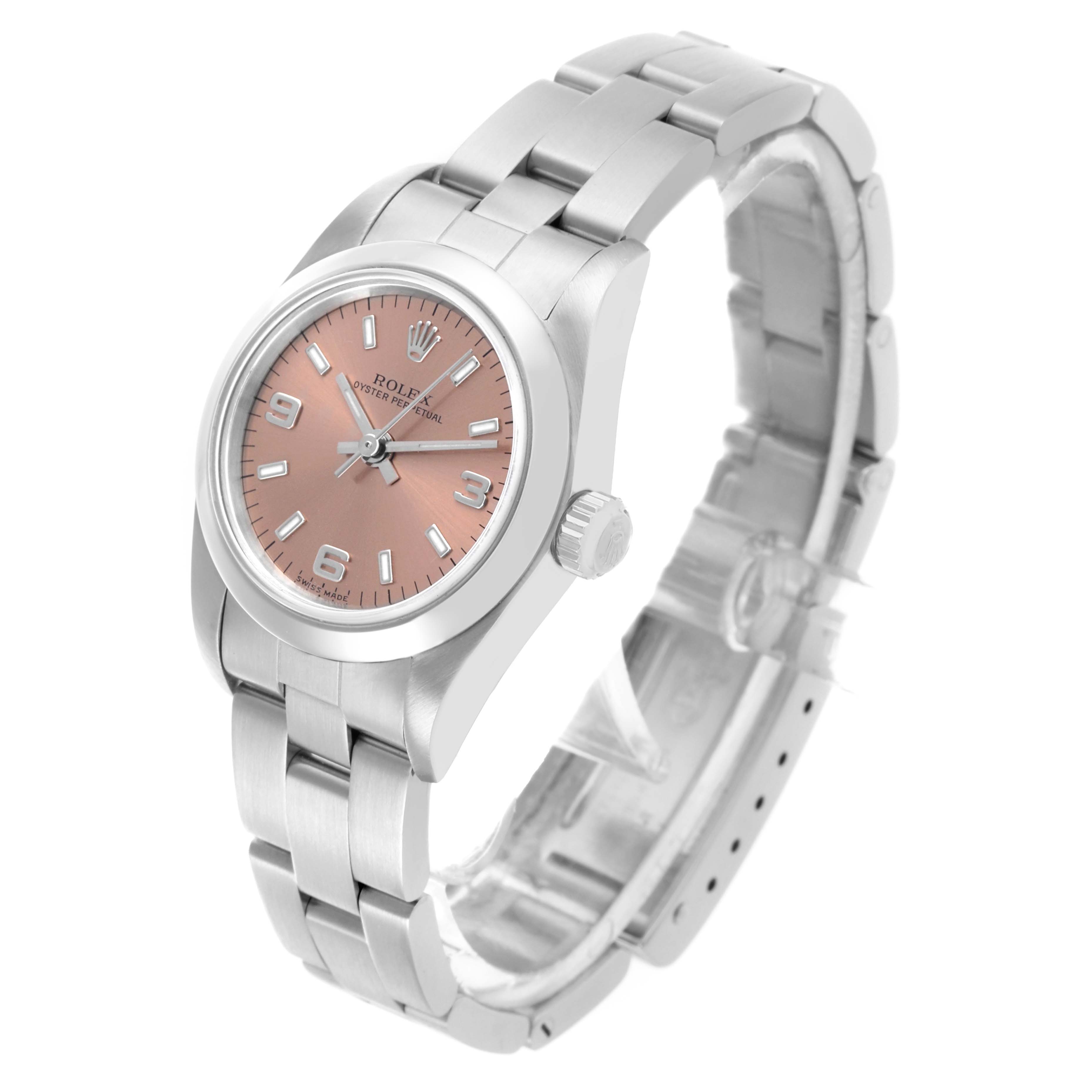 The Rolex Oyster Perpetual 76080 Women's Stainless Steel Pink Dial 76080 Women's Stainless Steel Pink Dial watch is shown at an angled side view, displaying the face, bezel, and bracelet.