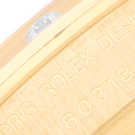 This is a close-up of the bezel of a Rolex Pearlmaster 80318 Women's Yellow Gold Champagne Dial 80318 Women's Yellow Gold Champagne Dial watch, showing part of the engraved model details.
