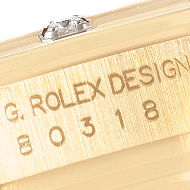 The image shows a close-up of the side of a Rolex Pearlmaster 80318 Women's Yellow Gold Mother of Pearl Dial 80318 Women's Yellow Gold Mother of Pearl Dial watch, prominently displaying the engraved model number and part of the case with a diamond accent.