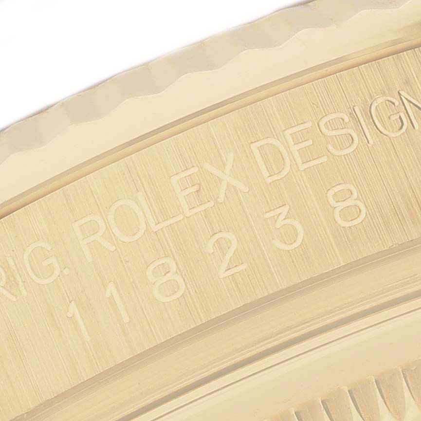 The image shows a close-up of the engraving on the Rolex President 118238 Men
s Yellow Gold Green Dial 118238 Men
s Yellow Gold Green Dial watch
s case side, highlighting the model number and brand.