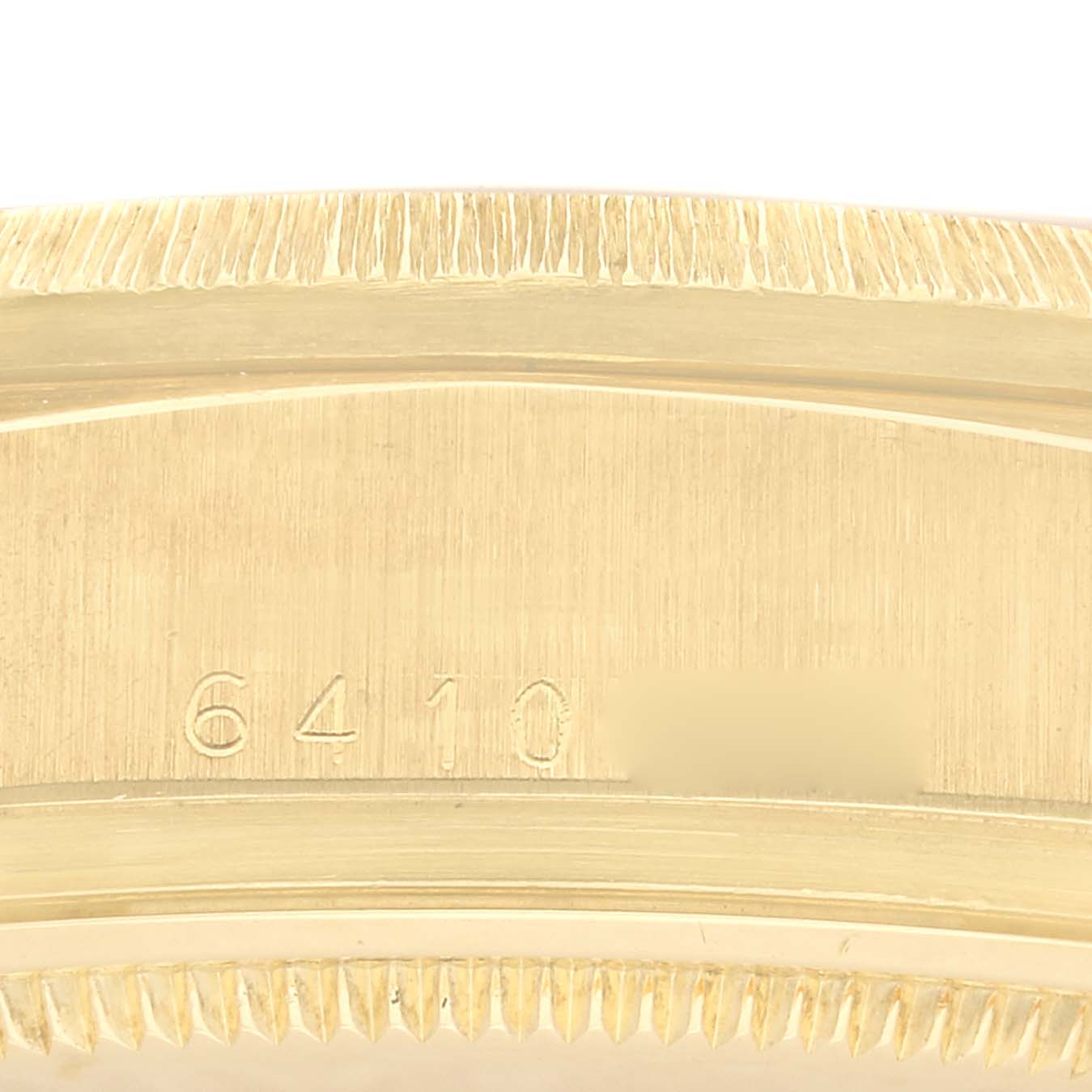 The image shows a close-up of the serial number and fluted bezel of a Rolex President 18078 Men's Yellow Gold Champagne Dial 18078 Men's Yellow Gold Champagne Dial model.