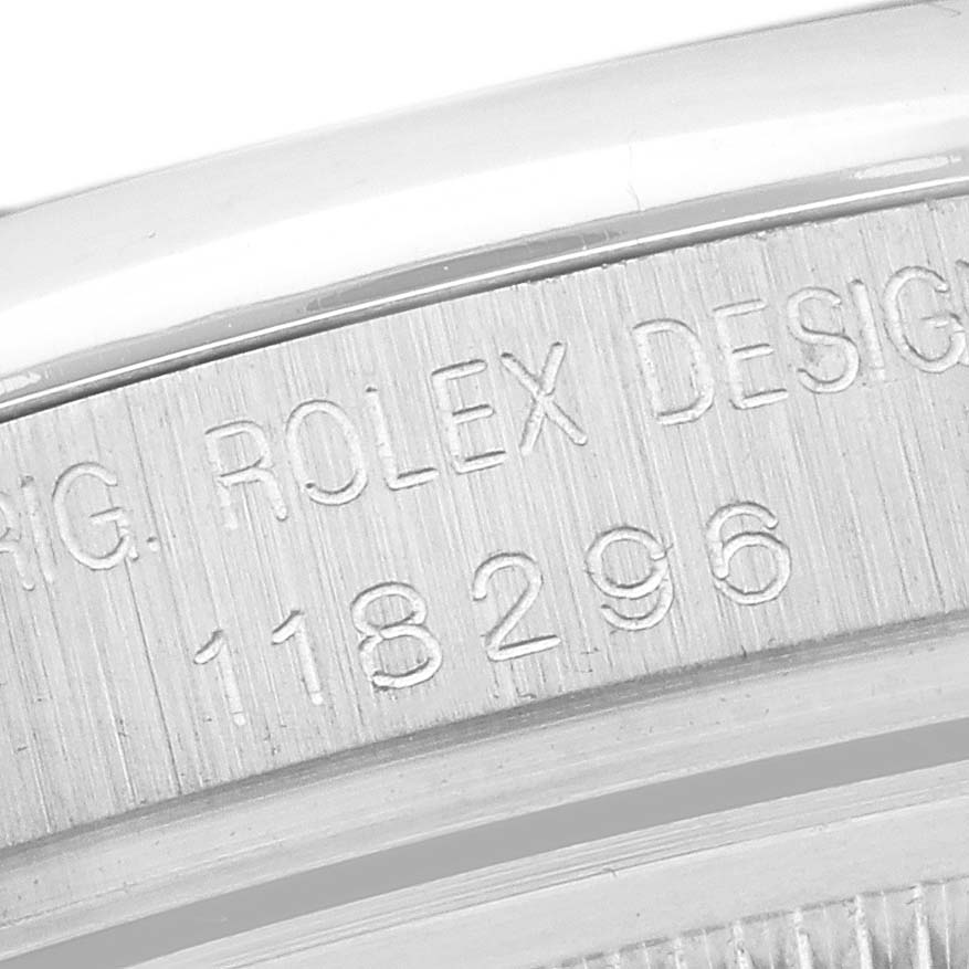 The image shows a close-up of the side of a Rolex President 118296 Men
s Platinum Blue Dial 118296 Men
s Platinum Blue Dial watch, highlighting the engraved model number.