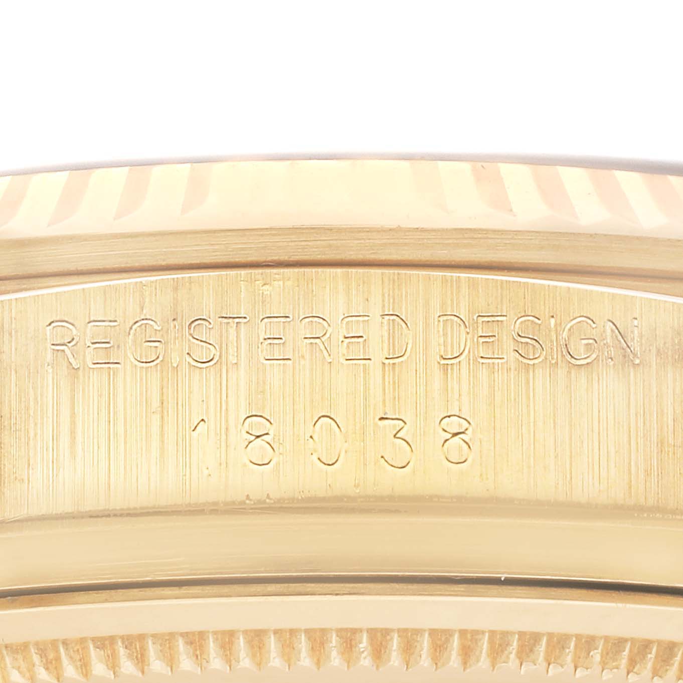 This is a close-up shot of the case back edge of a Rolex President 18038 Men's Yellow Gold Blue Dial 18038 Men's Yellow Gold Blue Dial model watch showing the registered design number "18038".