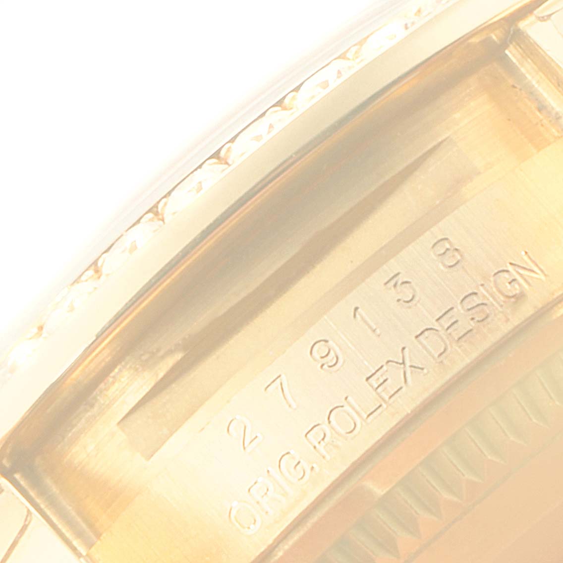 This image shows a close-up of the side of the Rolex President 279138 Women's Yellow Gold Silver Dial 279138 Women's Yellow Gold Silver Dial watch, highlighting its serial number and design engraving.