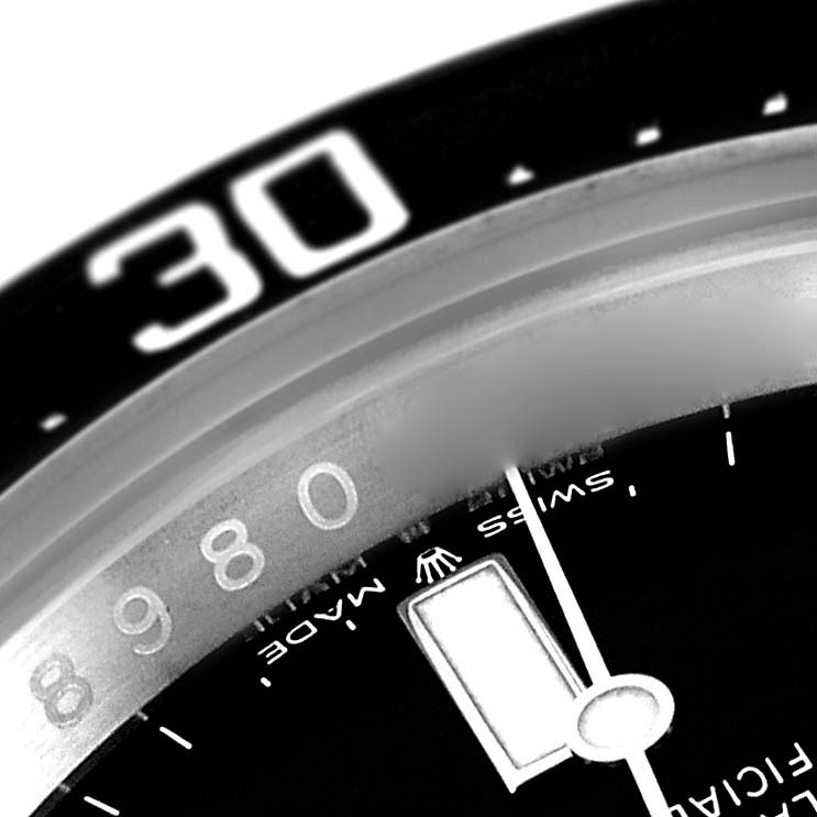 This close-up image of a Rolex Sea-Dweller 126600 Men
s Stainless Steel Black Dial 126600 Men
s Stainless Steel Black Dial watch shows part of the bezel, dial, and a hand.