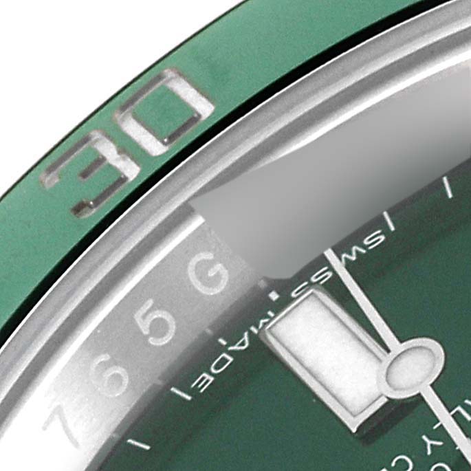This close-up image of a Rolex Submariner 116610LV Men
s Stainless Steel Green Dial 116610LV Men
s Stainless Steel Green Dial watch shows the green bezel with the "30" marker and part of the watch face and hands.