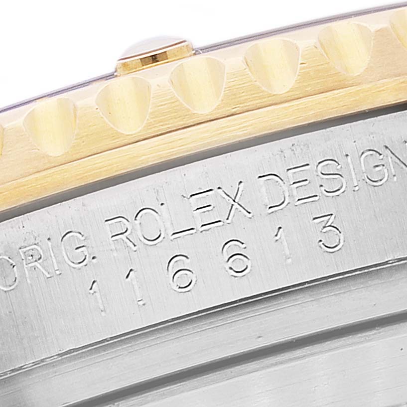 The image shows a close-up angle of the Rolex Submariner 116613 Men's Steel and Gold (two tone) Blue Dial 116613 Men's Steel and Gold (two tone) Blue Dial's bezel edge and engraved case back with the model number 116613.