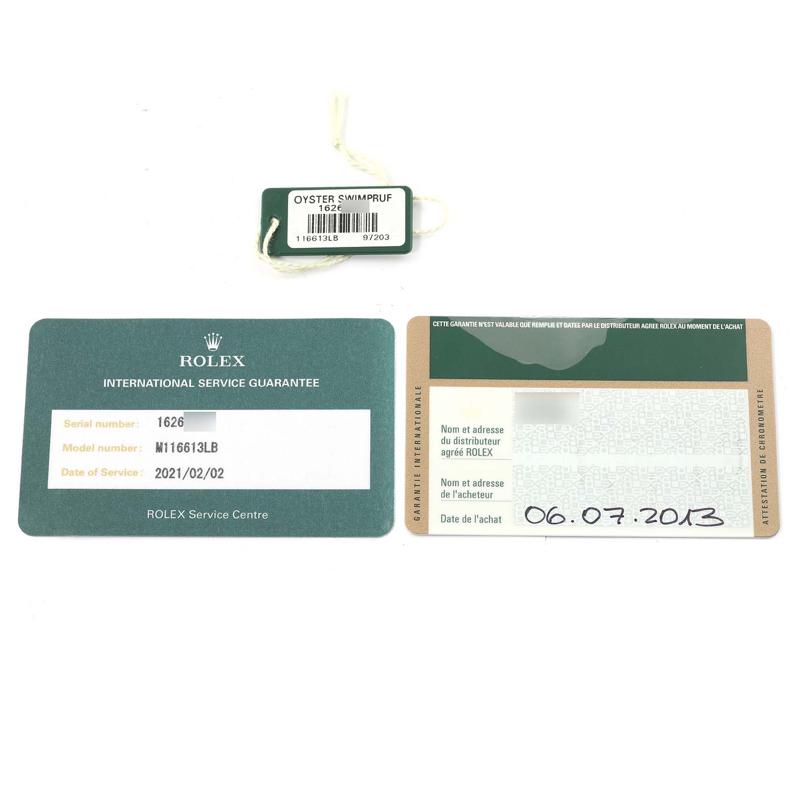 The image shows a Rolex Submariner 116613 Men's Steel and Gold (two tone) Blue Dial 116613 Men's Steel and Gold (two tone) Blue Dial's International Service Guarantee card, a guarantee card, and an Oyster Swimpruf tag.