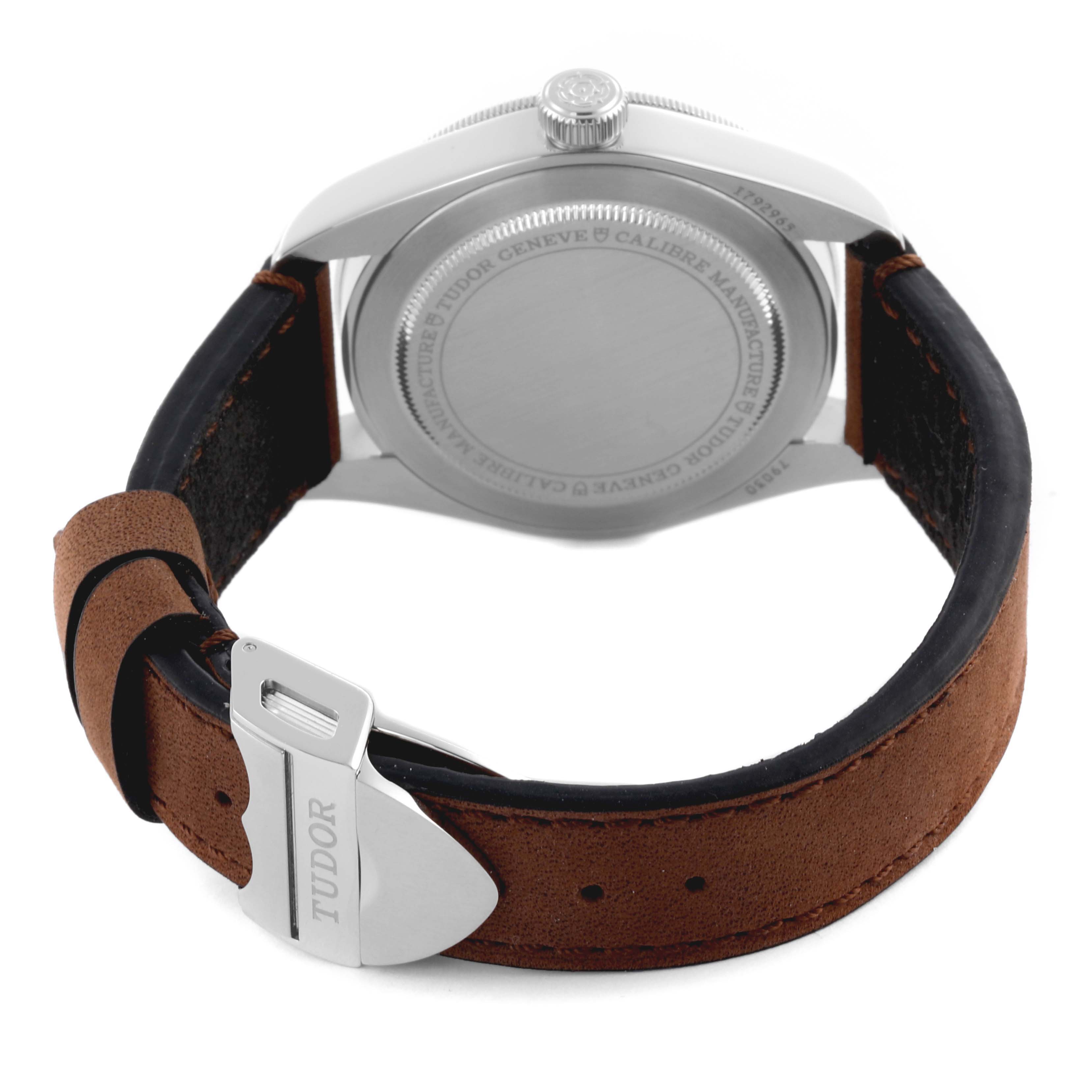 The image shows the back case and clasp of a Tudor Heritage Black Bay 79030N-0002 Men's Stainless Steel Black Dial 79030N-0002 Men's Stainless Steel Black Dial watch, with a brown leather strap.